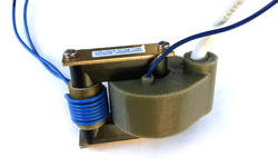 Coiltron high-voltage trigger transformer featuring blue insulated primary windings and a green molded secondary housing with a heavy-duty white output cable.