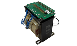 Large Coiltron transformer assembly featuring an integrated green PCB with terminal pins, blue wiring harnesses, and a vertical black laminated core with mounting brackets.