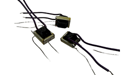 Three small Coiltron power transformers with metal frames and purple and black insulated wire leads, showcasing compact custom magnetic designs.
