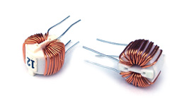 Two Coiltron toroidal common-mode chokes with copper windings on white integrated mounting bases, featuring four through-hole PCB leads.