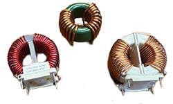 A collection of Coiltron toroidal magnetic components, featuring a green core inductor and a large common-mode choke with a vertical separator on a PCB mounting base.