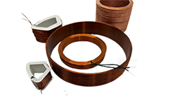 Collection of custom copper electromagnetic coils in various shapes and sizes including circular and wedge-shaped windings.