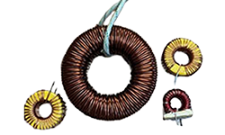 A collection of four custom toroidal inductors and coils wound with copper wire, showcasing a range of sizes and designs, isolated on a white background.